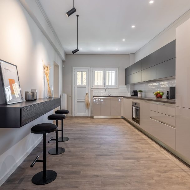 beehive apartments kipseli athens sitting area with kitchen view